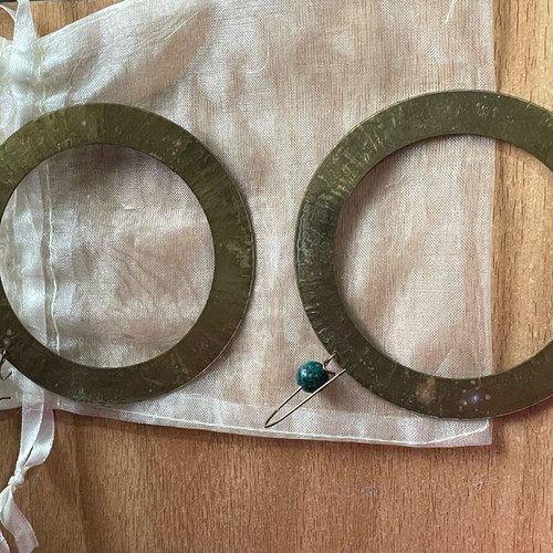 Handmade earrings used, round flat with green bead decoration