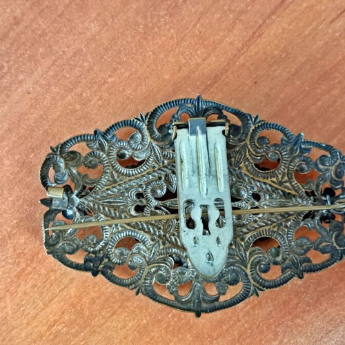 Vintage brooch used with floral filigree design and green stones