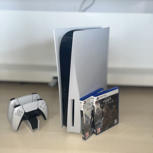 PlayStation 5 console used with two Assassin’s Creed games and DualSense controllers