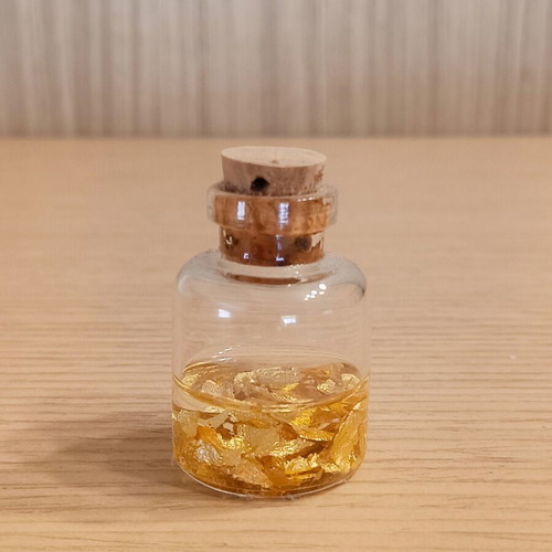 Small decorative bottle with 22K gold leaves