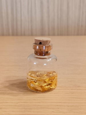 Small decorative bottle with 22K gold leaves