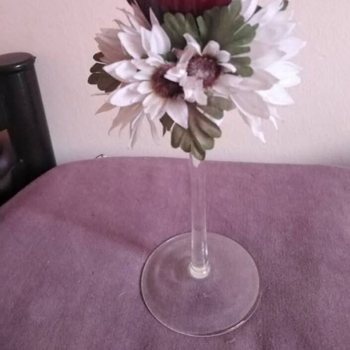Glass candlestick used with floral wreath and burgundy candle