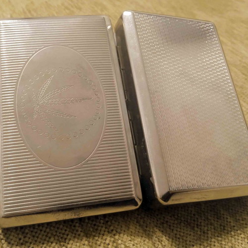 Tobacco case and metal cigarette roller used