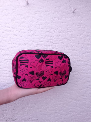 Toiletry bag used pink with heart patterns