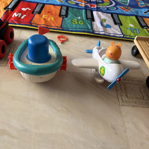 Toy set used with musical mat piano, remote car, boat, airplane, truck, football, figurine