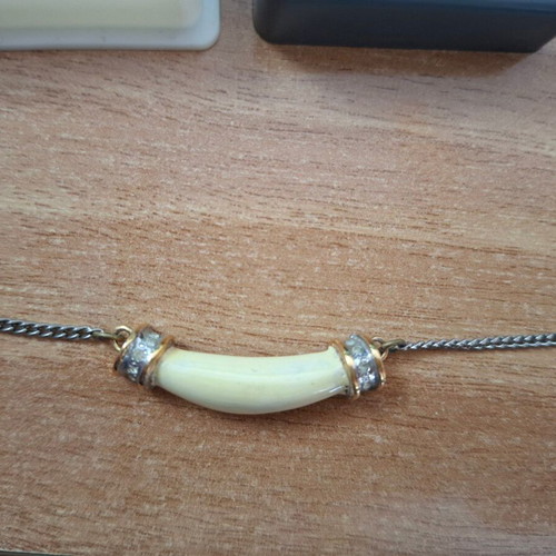 Necklace with ivory tusk pendant used, gold caps and strass decoration
