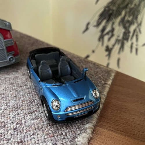 Toy cars, some unused, plastic and metal Mini Cooper