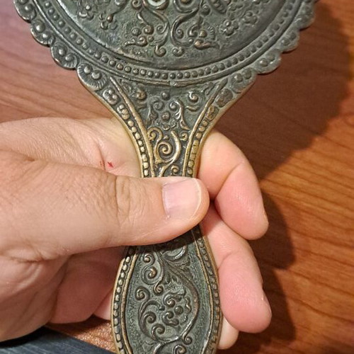 Brass hand mirror used with embossed peacock decoration