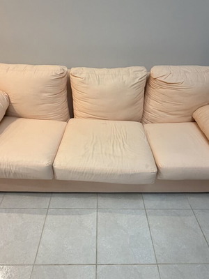 Three-seater fabric sofa used, light pink-peach color with side cushions