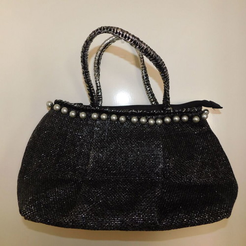 Handheld straw bag metallic like new with feather design and pearl accessory