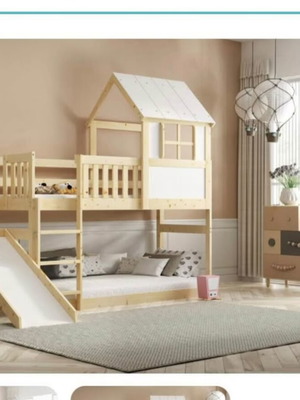 Elevated playhouse bed with slide and foam mattress