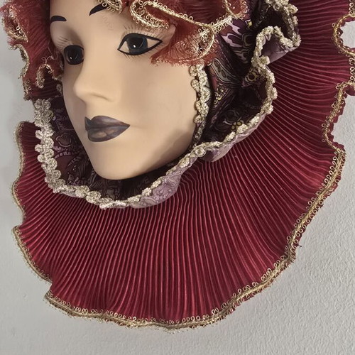 Decorative porcelain wall mask used with fabric hat in burgundy
