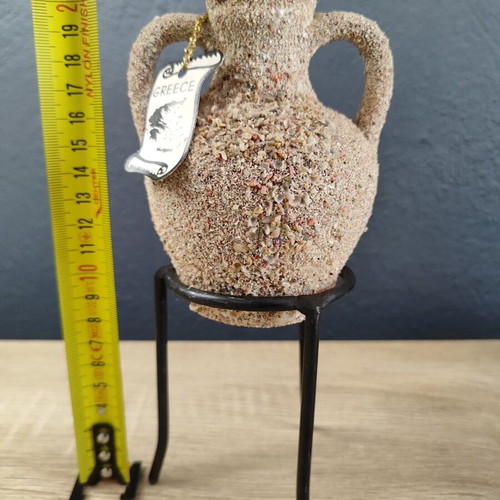 Handmade ceramic amphora decorative vase on metal base used