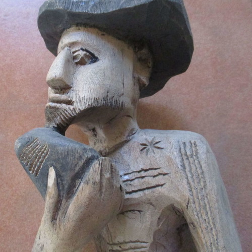 Wooden carved figure used from Colombia with traditional Pan flute