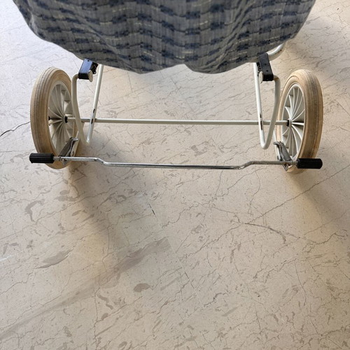 Vintage baby stroller with classic check fabric and metal frame