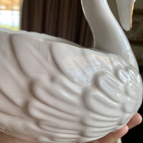 Vintage ceramic swan pair with glossy white finish and gold beak
