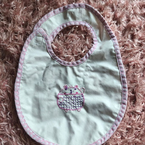 Baby bib "O kosmos tou moro" like new, white with pink details