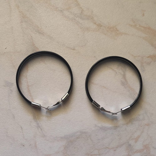 Large black hoop earrings used with silver details