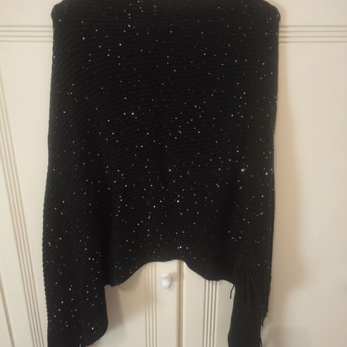 Black knitted poncho size S with subtle shiny sequins and fringes