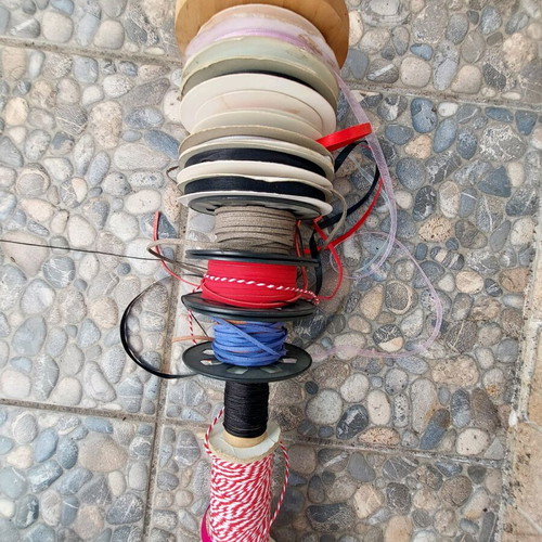 Wooden base with ribbons used for jewelry