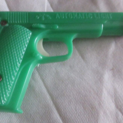 Plastic toys from the 70s like new pistol, flashlight, watch, spinning tops