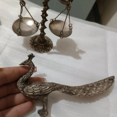 Vintage metal scale and decorative peacocks used