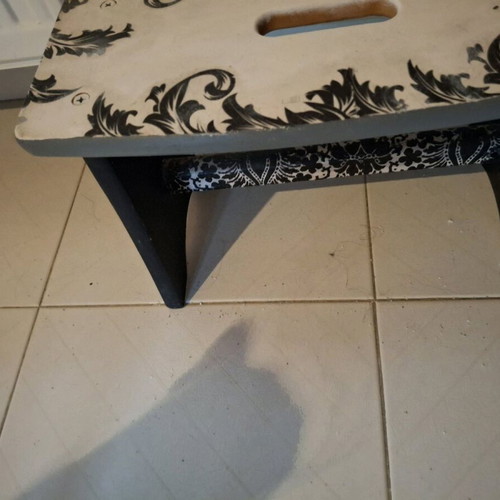 Footstool used with black and white decoupage technique