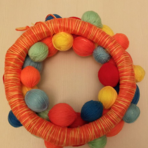 Decorative wreath used made of colorful wool yarn balls