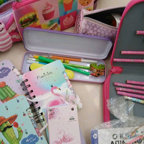 School supplies used, pencil cases, erasers, paints, notebooks, pencils