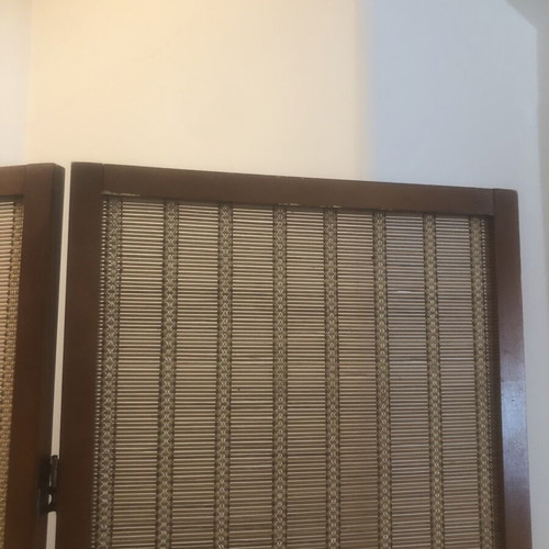 Brown bamboo room divider with slight wear