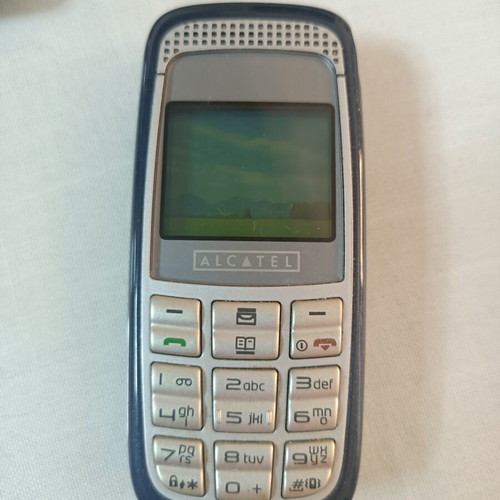 Alcatel mobile phone used, non-functional, with original charger