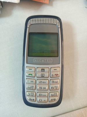 Alcatel mobile phone used, non-functional, with original charger
