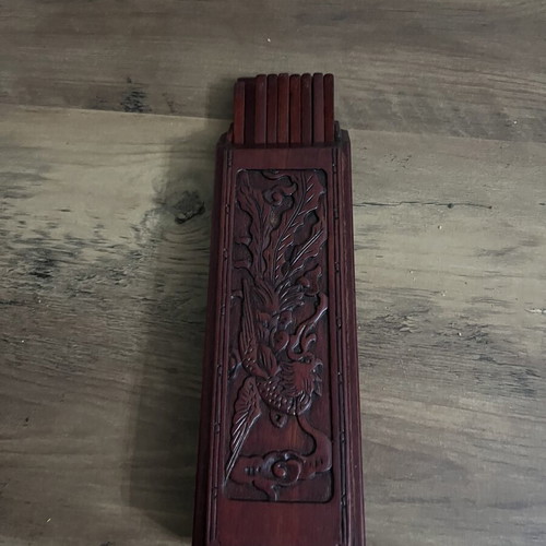 Japanese wooden box with 16 used chopsticks and palm carving