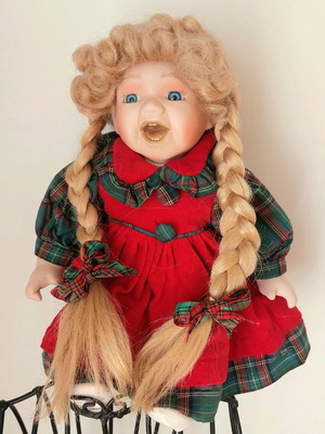 Vintage porcelain doll sitting, like new, red dress with green details