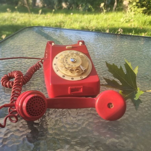 Vintage red wired telephone used