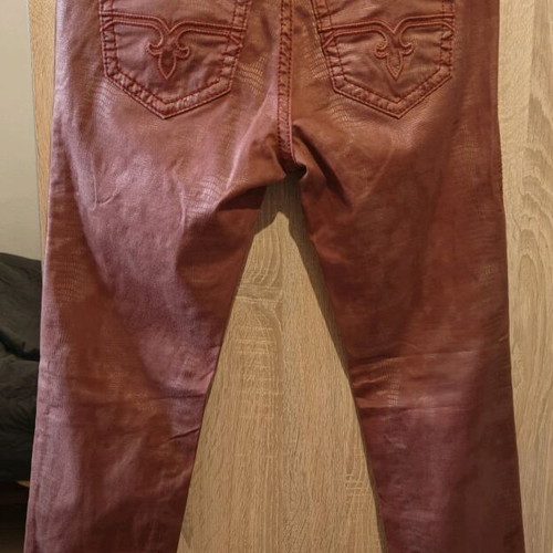 Rock Revival women's low rise red snake embossed denim jeans used