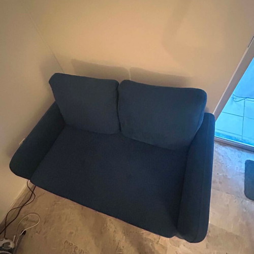 Blue two-seater sofa used with metal legs