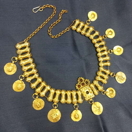Traditional necklace with vintage symbols used, yellow light color, copper