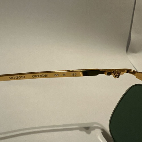 Vintage Vogue sunglasses with gold metal frame and green lenses