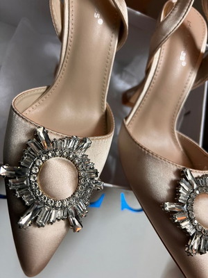 Women's pumps with unique heel and buckle, champagne color like new