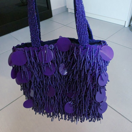 Purple handheld bag with shoulder strap