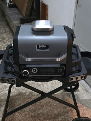 Ninja Woodfire OG701EU Electric BBQ Grill & Smoker used with stand and accessories