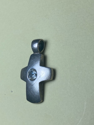 Silver cross used with stone