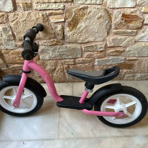 Balance bike pink like new with minor scratches on handlebar