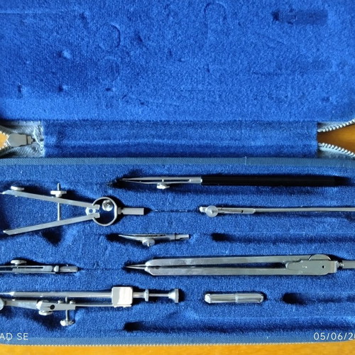 Drafting compass set used, missing one compass