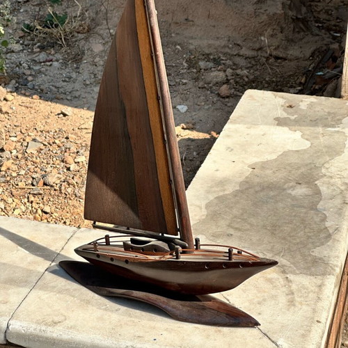 Handmade wooden sailboat used on base, modern nautical decoration