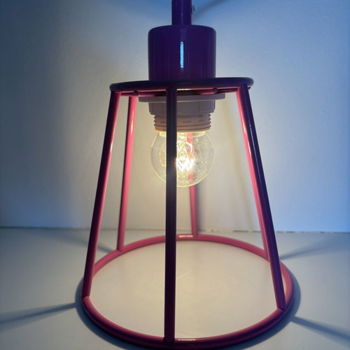 Metal ceiling pendant light in industrial cage style, fuchsia pink