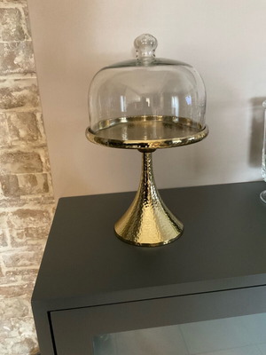 Metallic hammered cake stand with glass lid used, gold color