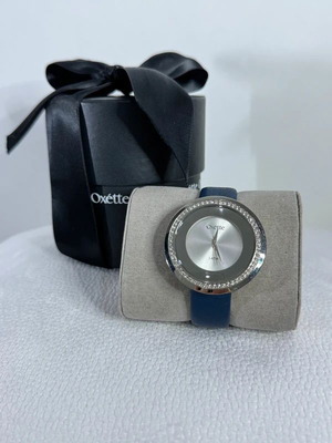 Oxette γυναικείο ρολόι σαν καινούργιο με μπλε δερμάτινο λουράκι και ασημί καντράν