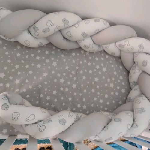 Baby braided crib bumper used in gray and white
